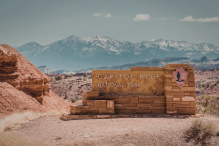 a sign for capitol reef national park in front of a mountain range