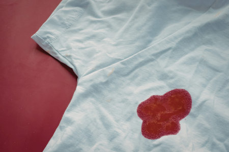 A red stain on a white t-shirt against a red background