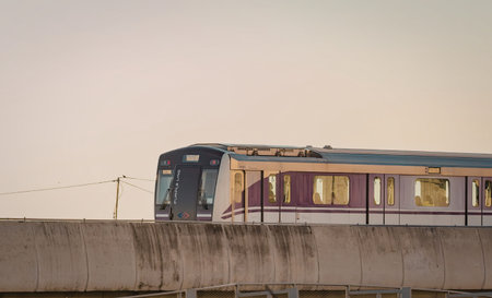 A train is on a concrete platform during sunset, showcasing a serene scene with warm lighting.
