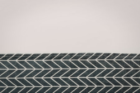 A dark green and white chevron pattern design element on a plain white background.