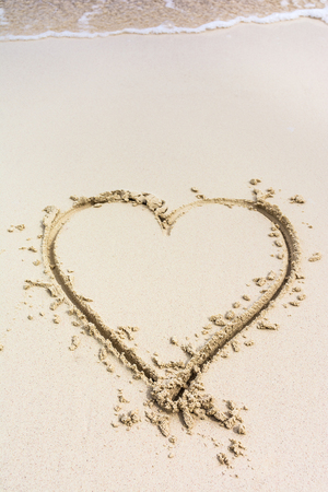 Heart drawn on caribbean white sandの写真素材
