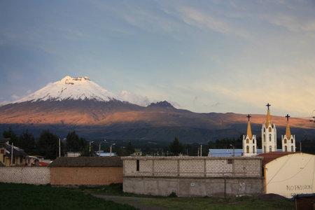 Church with the Cotopaxi volcano at the background. Evening light. Ecuador.の写真素材