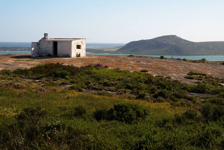 Ruin of a white house build on a rock on a hill with a beautiful viewの写真素材