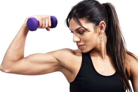 Beautiful brunette woman exercising with purple dumbbells