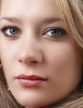 Portrait of a beautiful blonde woman with dark blue eyes and natural make-upの写真素材
