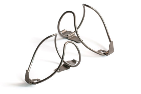 Stainless steel water bottle cages for bicycles on white background.