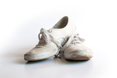 The old vintage white sneakers dirty isolated on white background.の写真素材