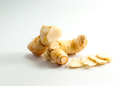 Galangal and sliced galangal on a white background.の写真素材
