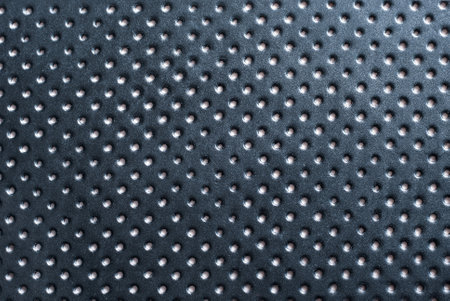 Top view of perforated black leatherette sheet for use as a background.の写真素材
