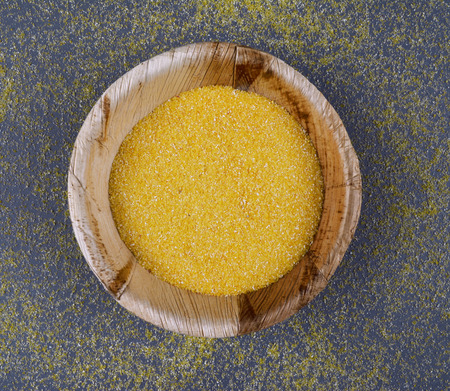 Corn meal of dry polenta on dark background. Flat lay style.の写真素材