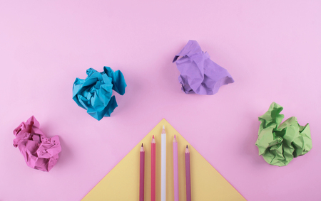 Colored pencils on pink and yellow background. Flat lay style with space for your text.の写真素材