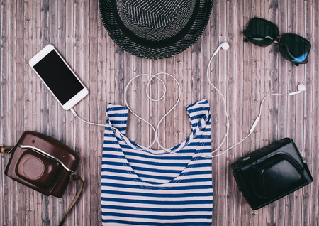 Mens casual outfits on wooden background essential vacation item for traveler. Flat lay style.