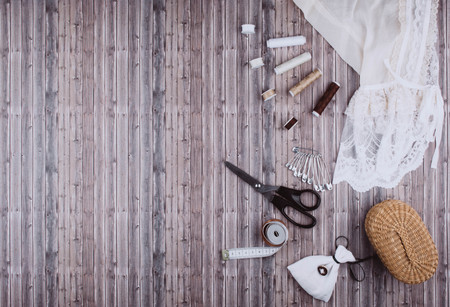 Background with stylish sewing tools and accessories on wooden table.の写真素材
