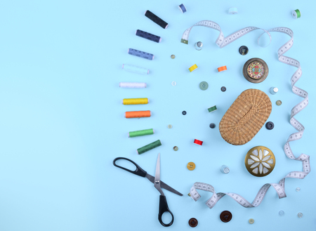 Background with stylish sewing tools and accessories on trendy blue background.の写真素材