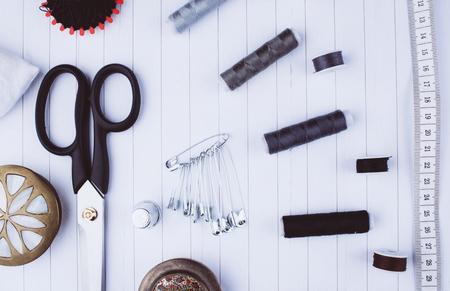 Background with stylish sewing tools and accessories on wooden table.の写真素材