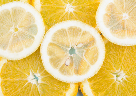 Fresh fruit in a cut on as background. Pattern of citrus fruits. Diet and healthy food concept. Flat...