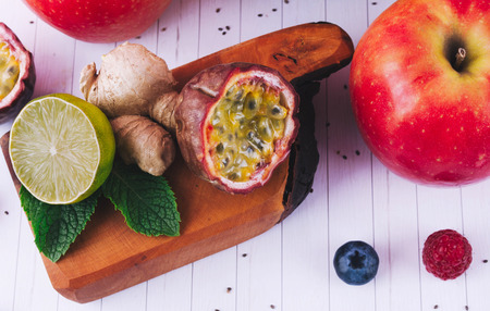Detox diet concept: pink smoothie with fruits and berries on white wooden table. Superfoods and healthy lifestyle.の写真素材