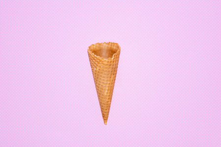 Empty ice cream cornet on pink background. Flat lay style.の写真素材