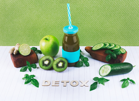 Detox diet concept: green smoothie with fruits and vegetables on white wooden table.の写真素材