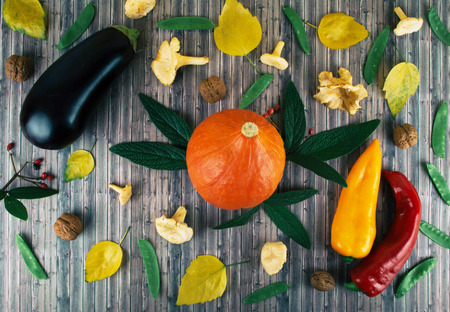 Tasty appetizing fresh autumn seasonal vegetables on old wooden background. Flat lay style with...