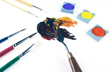 Multicolor oil paint brush strokes with knife on white background. Flat lay style. Art and  education concept.の写真素材