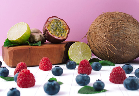 Detox diet concept: fruits and berries on white wooden table. Superfoods and healthy lifestyle.の写真素材