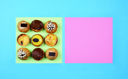 Delicious various pastries on trendy blue background. Flat lay style.