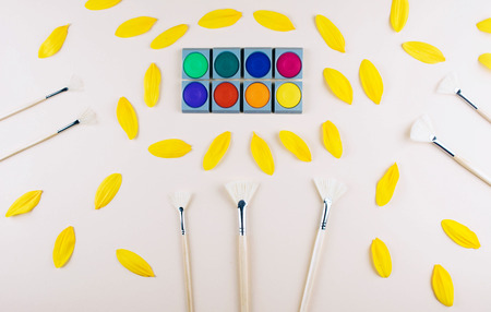Watercolor and brushes at beige background. Flat lay, top view. Art and education concept.の写真素材