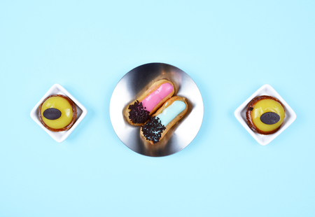 Delicious various pastries on trendy blue background. Flat lay style. 