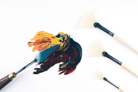 Multicolor oil paint brush strokes with knife on white background. Flat lay style. Art and  education concept.の写真素材