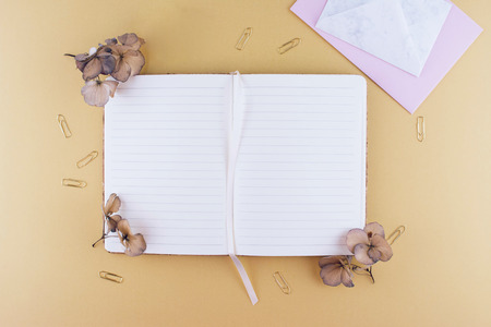 Still life business office supplies or education concept. Top view image of notebook with with pen and dry flowers.の写真素材