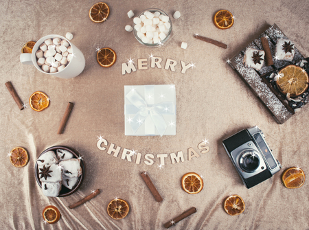 Christmas composition: christmas gift with decoration, orange cake, hot cacao with marshmallows. Flat lay style, top view.の写真素材
