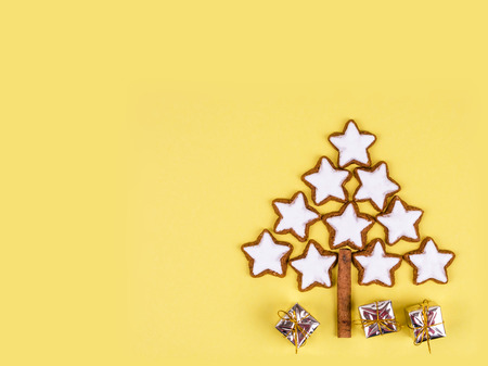Bright winter holidays christmas composition with gifts and christmas tree made of cinnamon cookies.の写真素材