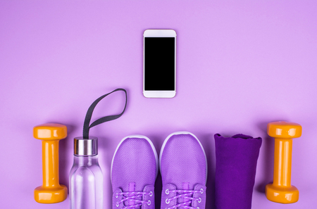 Creative flat lay of sport and fitness equipments on lilac background with copy space.の写真素材