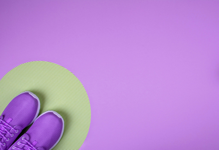 Flat lay shot of sneakers on lilace background with copy space for your text. の写真素材