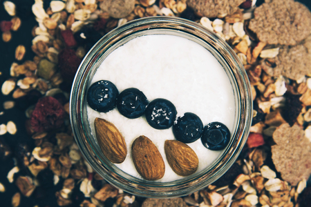 Healthy breakfast fresh granola muesli with berries and fruits in a glass jar.の写真素材