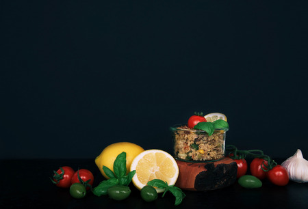 Dietary menu healthy vegan salad of vegetables broccoli mushrooms spinach and quinoa in a jar on a black background.の写真素材