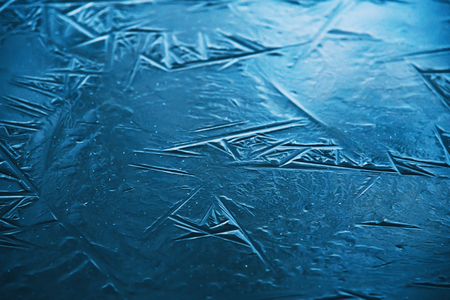 Close up of the ice of a clear frozen lake.