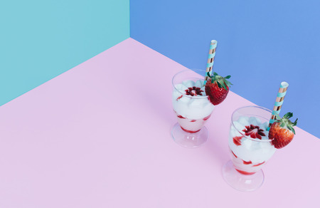 Milkshake with straw and strawberry.の写真素材