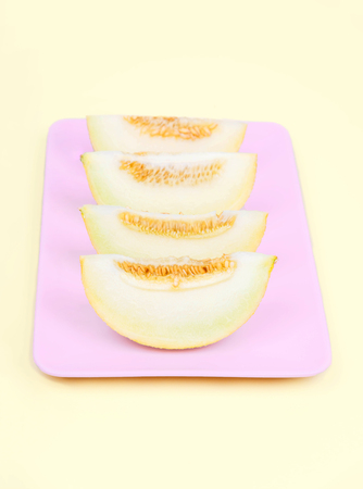 Fresh melone on pastel yellow background.の写真素材