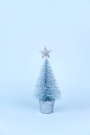 Christmas tree over light blue background. Xmas and holiday concept.の写真素材