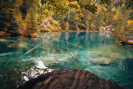 Autumn time at romantic forest lake Blausee, one of the best known mountain lakes in Switzerland.
