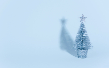 Christmas tree over light blue background. Xmas and holiday concept.の写真素材