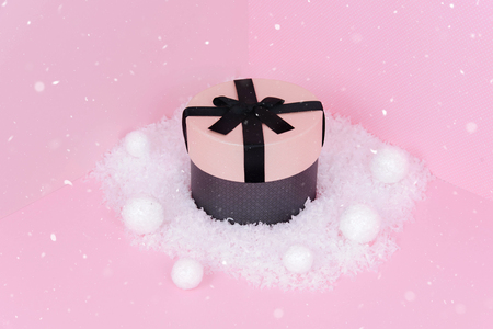 Pink gift box with ribbon on a pink background with copy space.の写真素材
