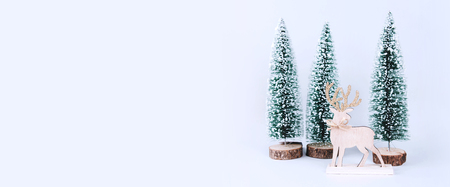 Christmas wooden tree with reindeer over light blue background. Xmas and holiday concept.の写真素材