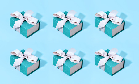 Pattern made of blue gift boxes on pastel background.