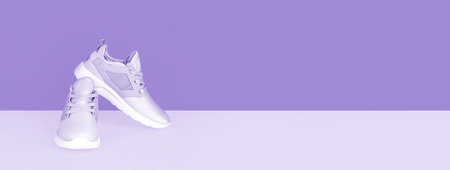 Shot of sneakers on lilac background. Stylish healthy lifestyle concept.の写真素材