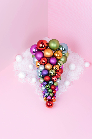 Christmas tree made of pink decoration on pink background. Xmas and holiday concept.の写真素材