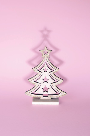 Christmas tree over pink background. Xmas and holiday concept.の写真素材