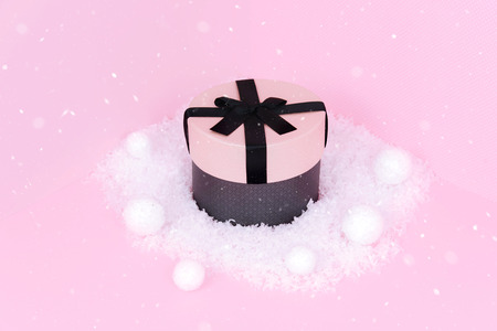 Pink gift box with ribbon on an pink background.の写真素材